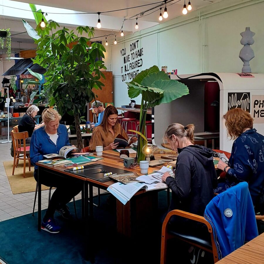 people sitting at a table making collages